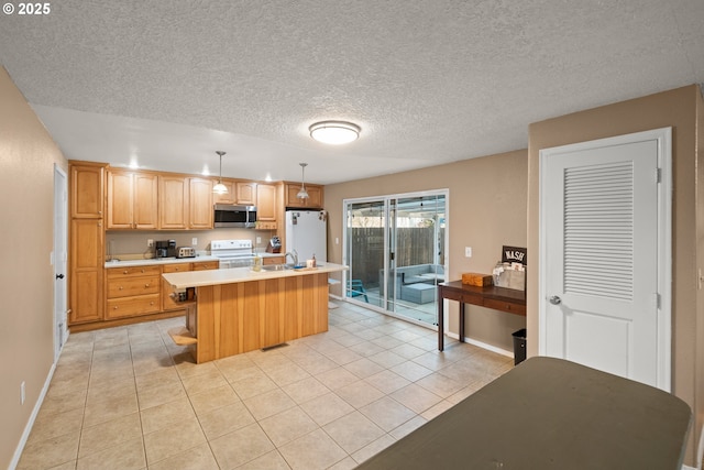 kitchen featuring sink, light tile patterned floors, an island with sink, pendant lighting, and white appliances