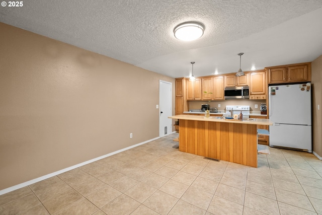 kitchen with a center island, a textured ceiling, light tile patterned floors, appliances with stainless steel finishes, and pendant lighting