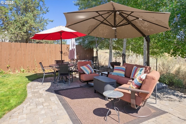 view of patio / terrace featuring an outdoor living space, outdoor dining area, and fence