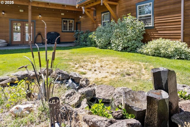 view of yard featuring french doors