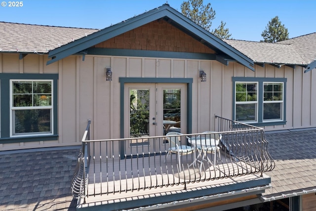 doorway to property with a shingled roof and board and batten siding