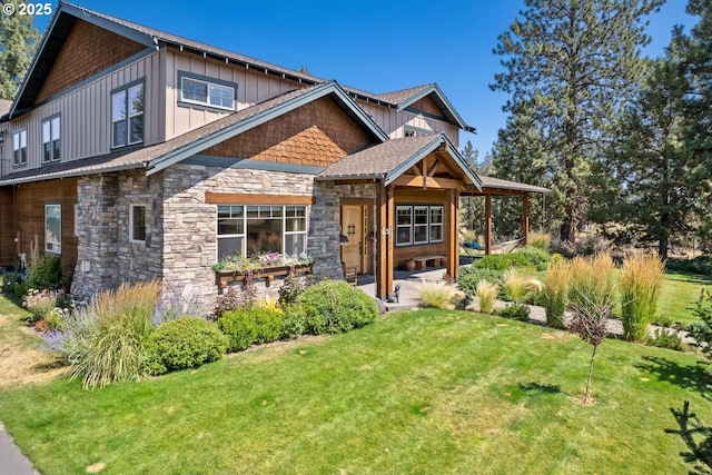 craftsman-style home featuring board and batten siding, a patio area, stone siding, and a front lawn