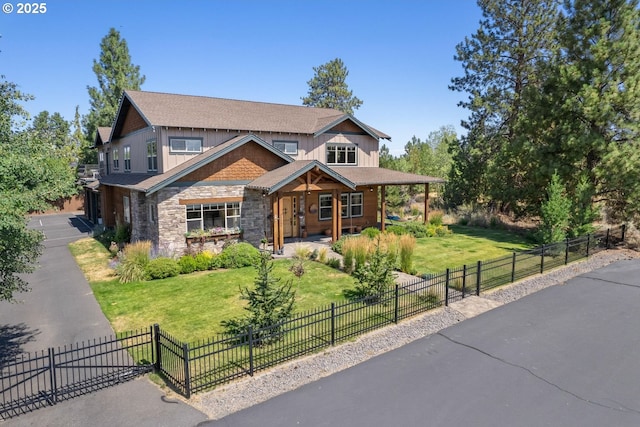 craftsman-style home with a porch, a fenced front yard, a front yard, and stone siding