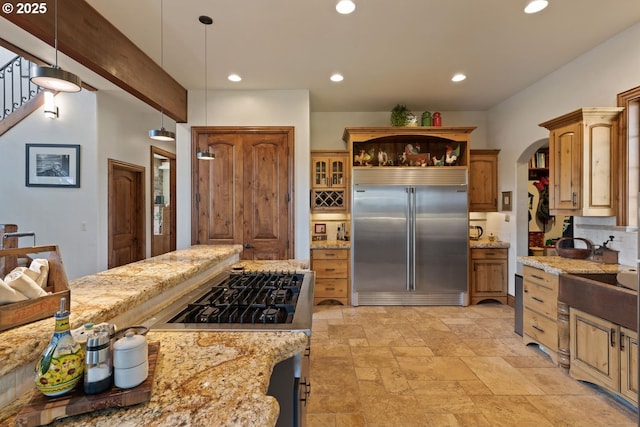 kitchen featuring decorative backsplash, stainless steel built in fridge, pendant lighting, stove, and recessed lighting