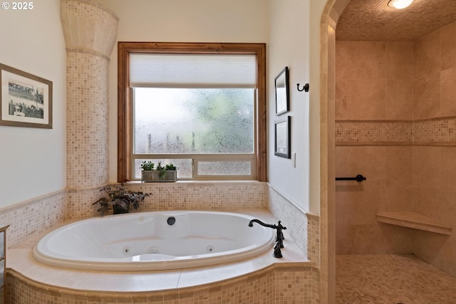 full bath with a whirlpool tub and tiled shower