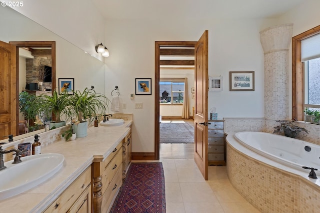 bathroom featuring double vanity, a sink, a whirlpool tub, and tile patterned floors