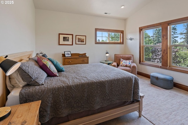 bedroom featuring carpet floors, baseboards, vaulted ceiling, and visible vents