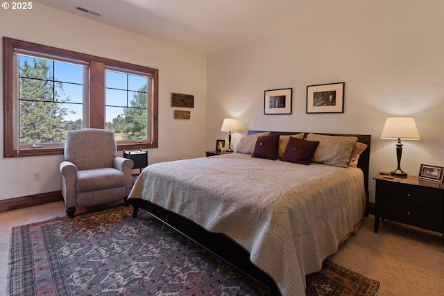 carpeted bedroom featuring visible vents and baseboards
