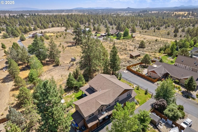birds eye view of property featuring a mountain view and a wooded view