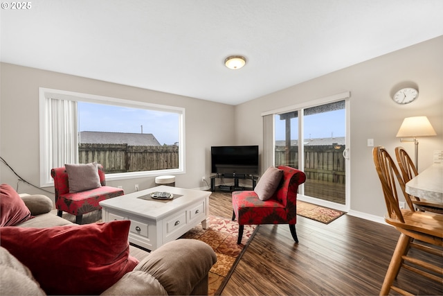 living area with wood finished floors and baseboards