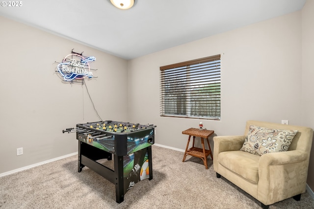 rec room with baseboards and carpet