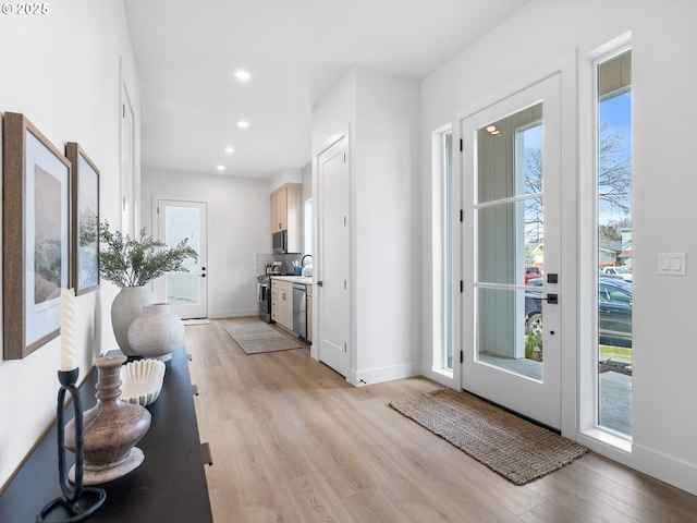 interior space featuring sink and light wood-type flooring