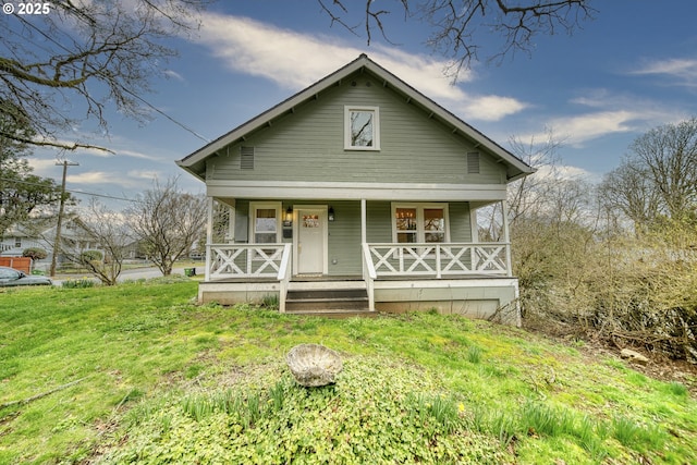 bungalow-style home with a porch and a front lawn