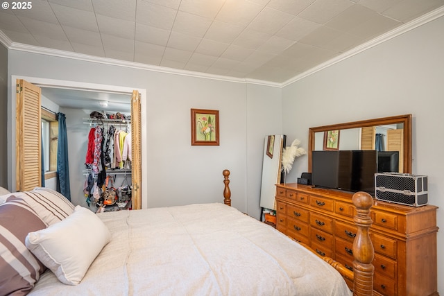 bedroom with a walk in closet, a closet, and crown molding