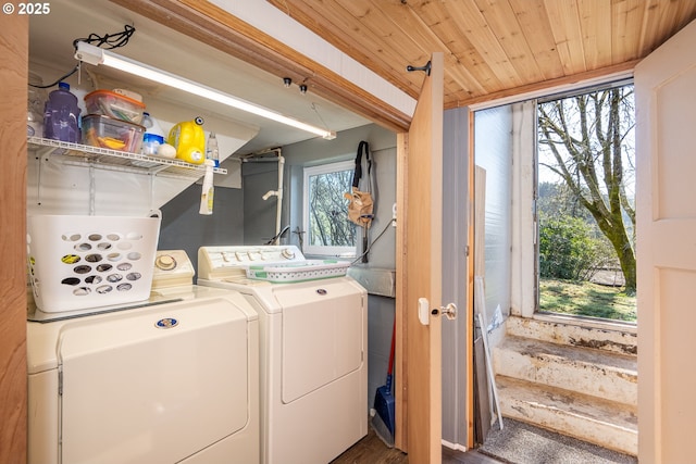 washroom featuring wood ceiling, laundry area, and separate washer and dryer