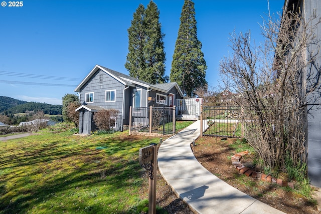 view of front of property featuring a fenced front yard and a front lawn