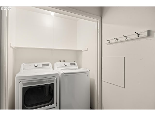 clothes washing area featuring laundry area and washing machine and clothes dryer