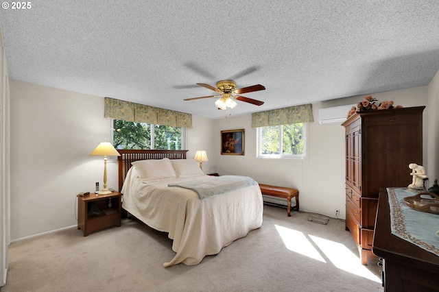 bedroom featuring a ceiling fan, a textured ceiling, light colored carpet, and multiple windows