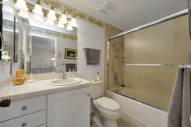 full bath featuring vanity, bath / shower combo with glass door, tile patterned flooring, and toilet