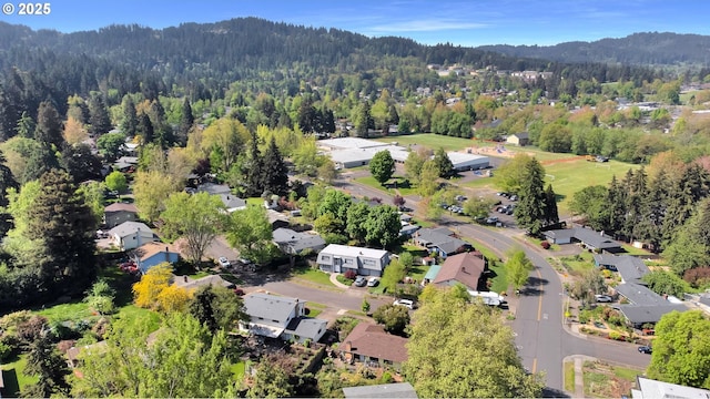 drone / aerial view with a residential view and a wooded view
