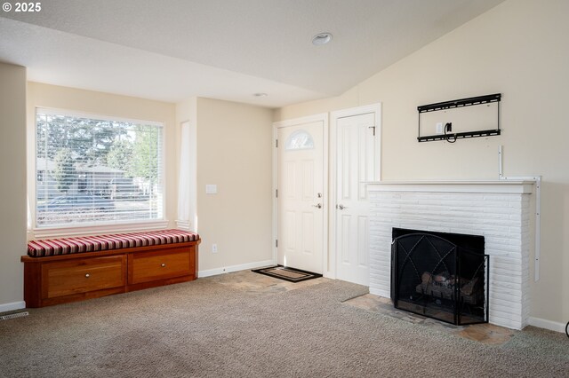 unfurnished living room with carpet floors, a fireplace, and vaulted ceiling