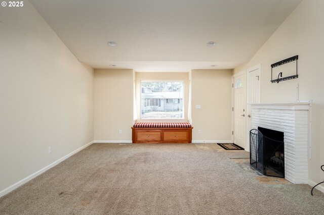 unfurnished living room with a fireplace and light colored carpet