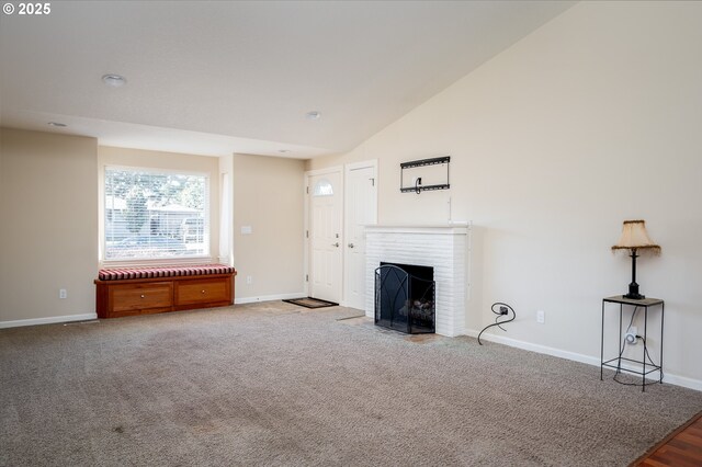 unfurnished living room with high vaulted ceiling, carpet floors, and a fireplace