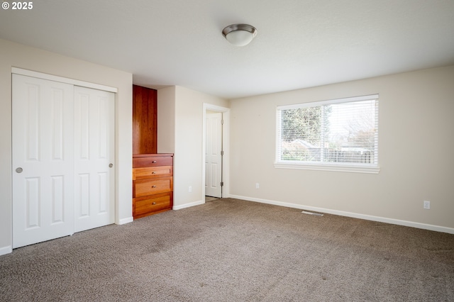 unfurnished bedroom featuring a closet and carpet