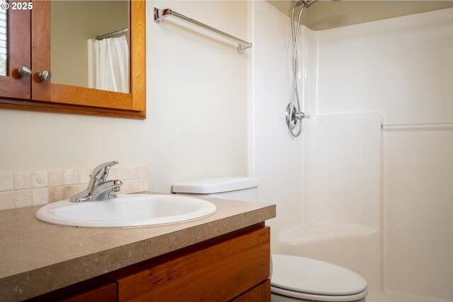 bathroom featuring vanity, toilet, and a shower with shower curtain