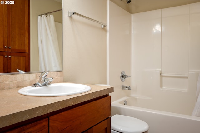 full bathroom featuring vanity, shower / bath combination with curtain, and toilet