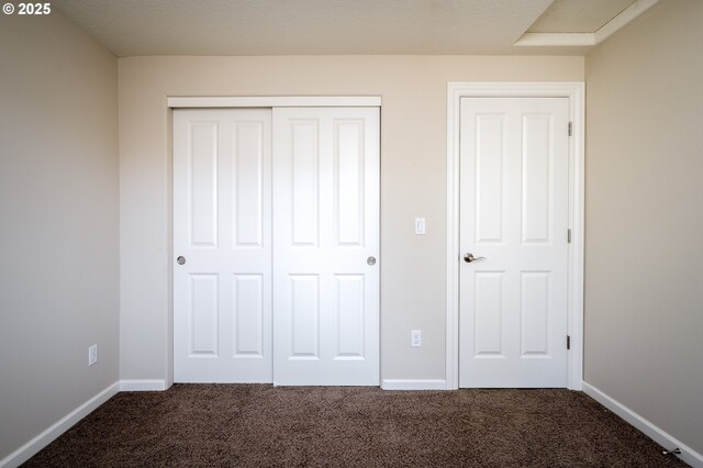 unfurnished bedroom featuring carpet and a closet