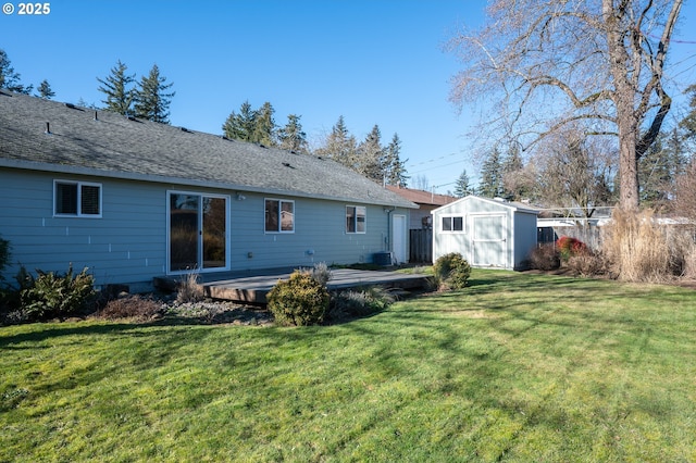 rear view of property with a shed and a lawn