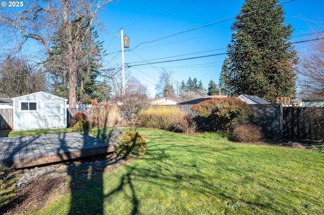 view of yard featuring a deck and a storage shed