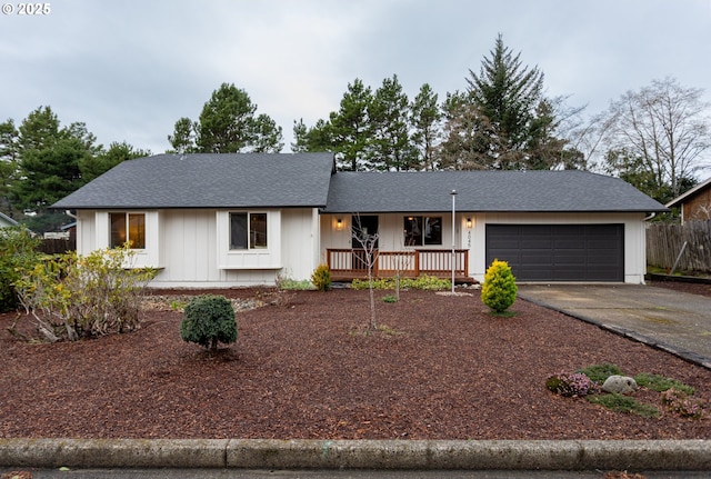 ranch-style house featuring a garage, a shingled roof, driveway, and fence