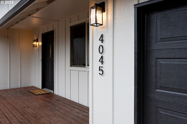 property entrance featuring board and batten siding