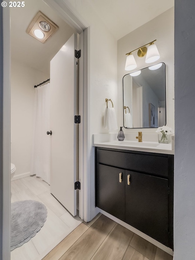 4045 Spruce St, Florence, OR 97439 - full bathroom with vanity, wood finished floors, toilet, and a shower with curtain