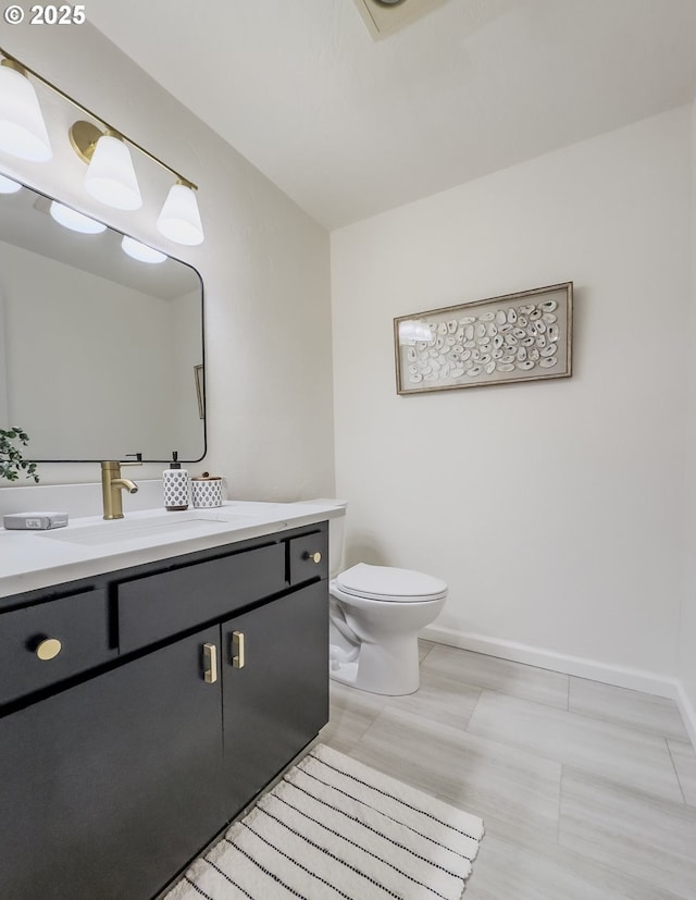 4045 Spruce St, Florence, OR 97439 - bathroom with vanity, toilet, and baseboards