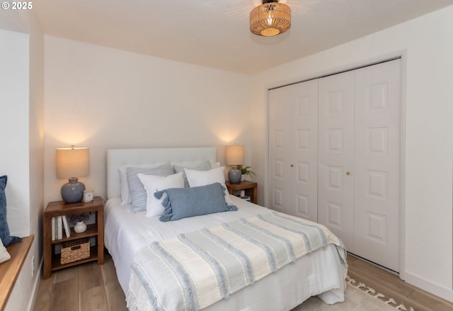 bedroom featuring a closet and light wood-style flooring