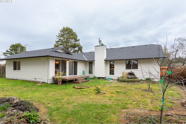 back of house featuring a shingled roof, fence, a chimney, a yard, and crawl space