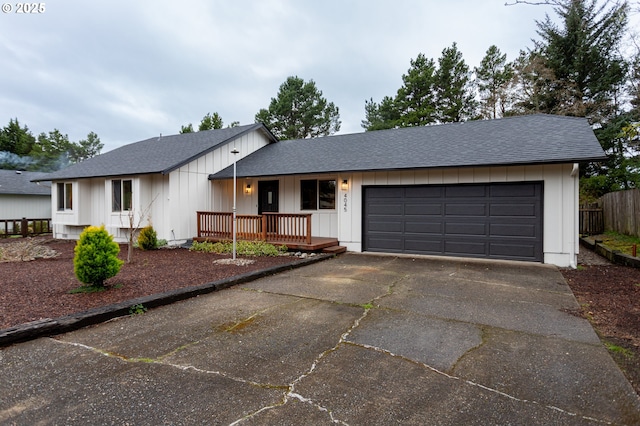 view of front facade featuring a garage, board and batten siding, concrete driveway, and a shingled roof