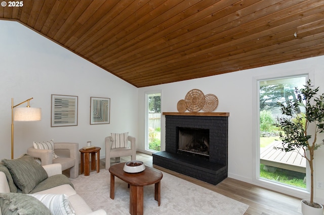 4045 Spruce St, Florence, OR 97439 - living area featuring vaulted ceiling, wooden ceiling, plenty of natural light, wood finished floors, and a brick fireplace