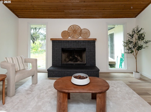 4045 Spruce St, Florence, OR 97439 - living area with wood ceiling, wood finished floors, a brick fireplace, and baseboards