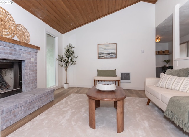 living area featuring visible vents, wood finished floors, a fireplace, lofted ceiling, and wood ceiling