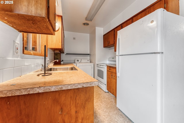 kitchen with washer / dryer, sink, backsplash, and white appliances