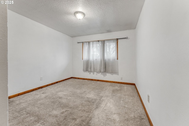 carpeted spare room featuring a textured ceiling