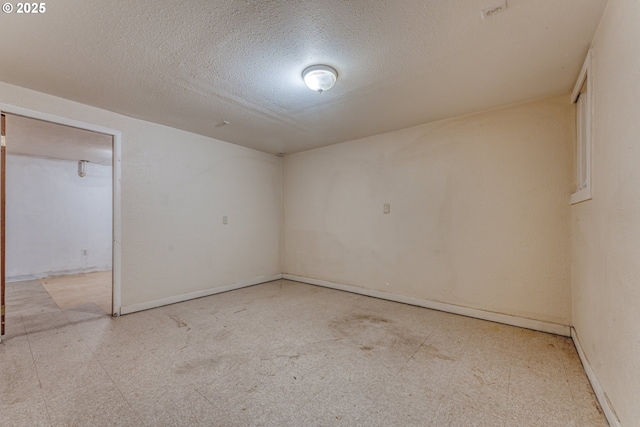 unfurnished room with a textured ceiling