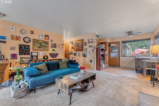 carpeted living room with ceiling fan