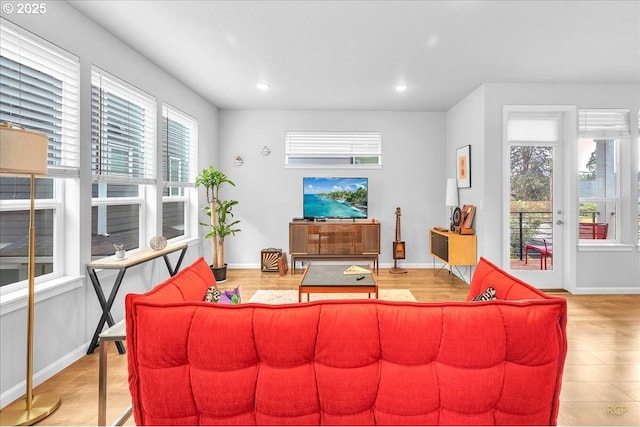 living room featuring baseboards and recessed lighting