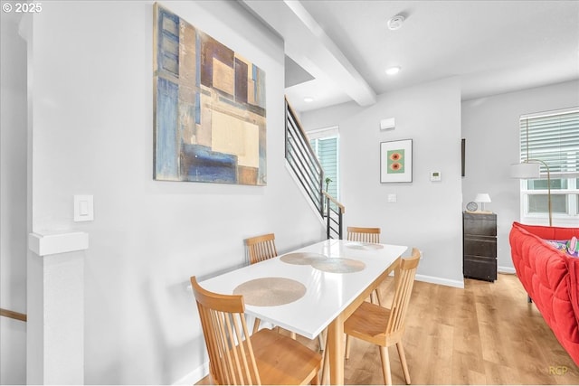 dining area featuring a wealth of natural light, light wood-style floors, stairway, and baseboards