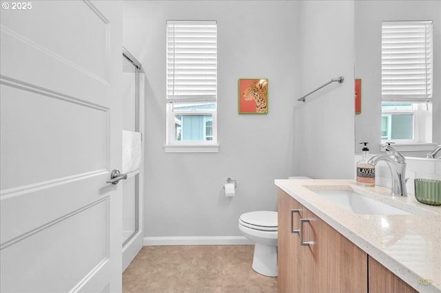 full bathroom with baseboards, a wealth of natural light, and a shower with door